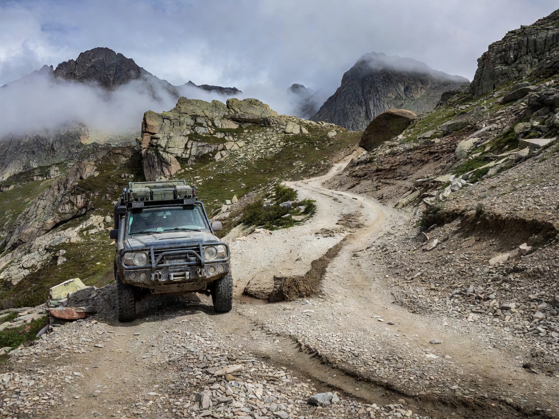 Outfitted expedition four-wheel-drive vehicle parked on a technical alpine gravel pass